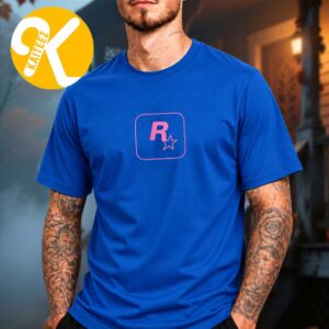 Male model wearing a royal blue T-shirt with a pink Rockstar R-star chest emblem enclosed by a rounded-square outline.